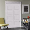 Beautiful solid white modern door with a chair beside it and a small table with tea cups and red flowers